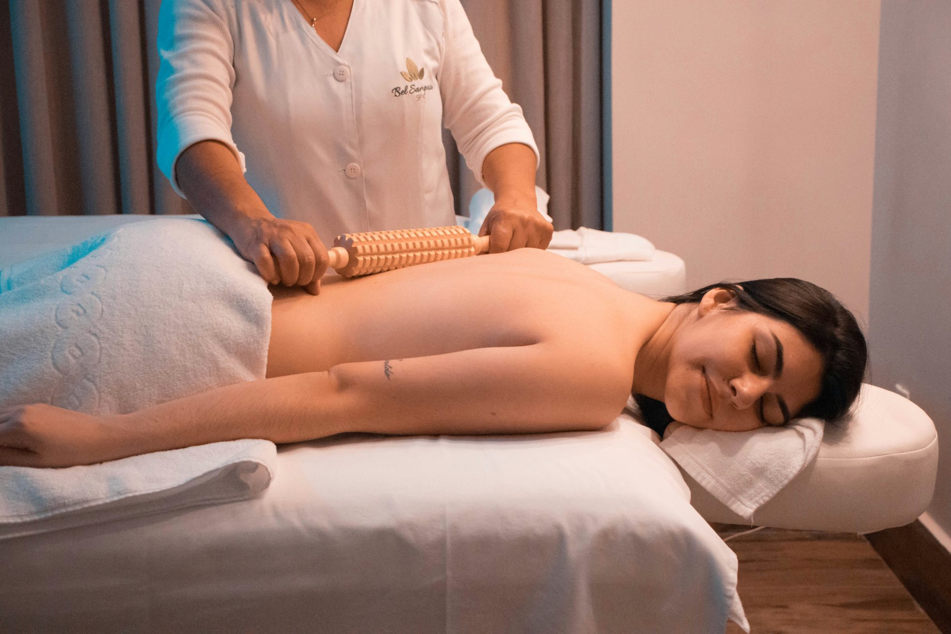 Back massage treatment with a roller tool in session