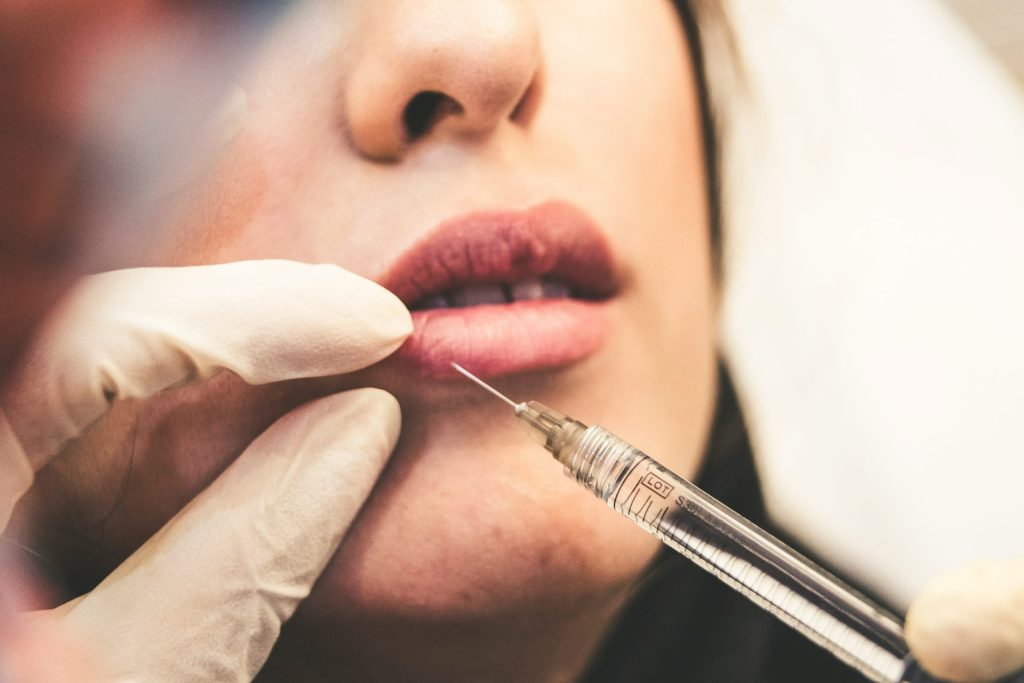 Lip filler injection being administered carefully