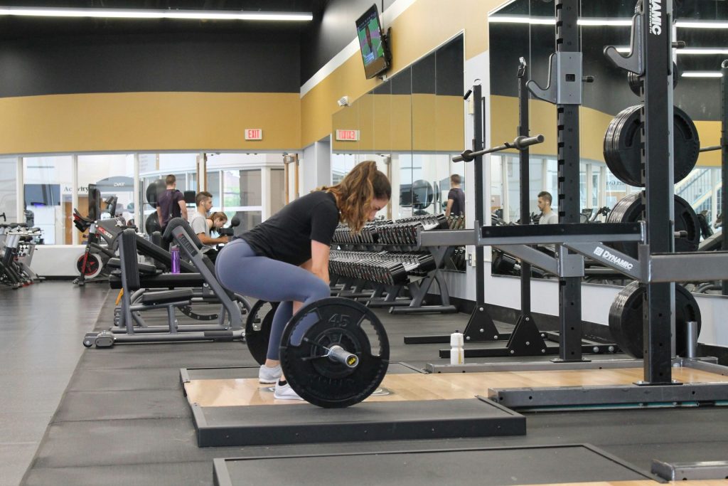 Woman performing a deadlift in the gym