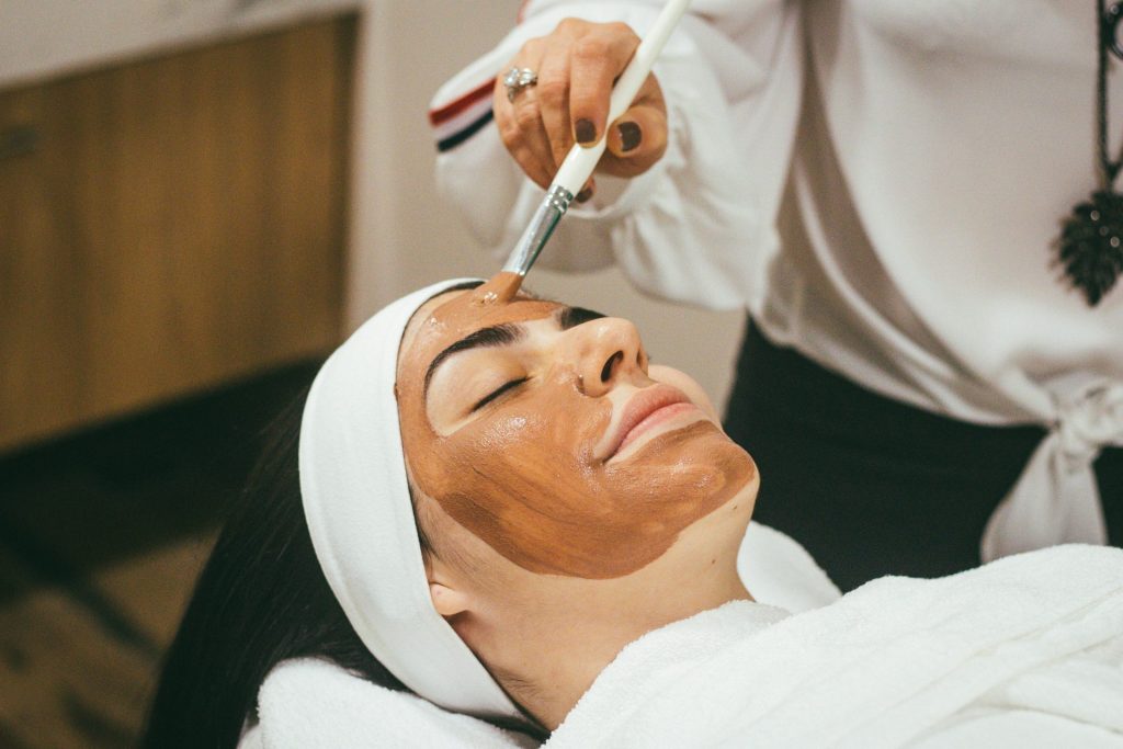 Skincare facial treatment with brown mask applied